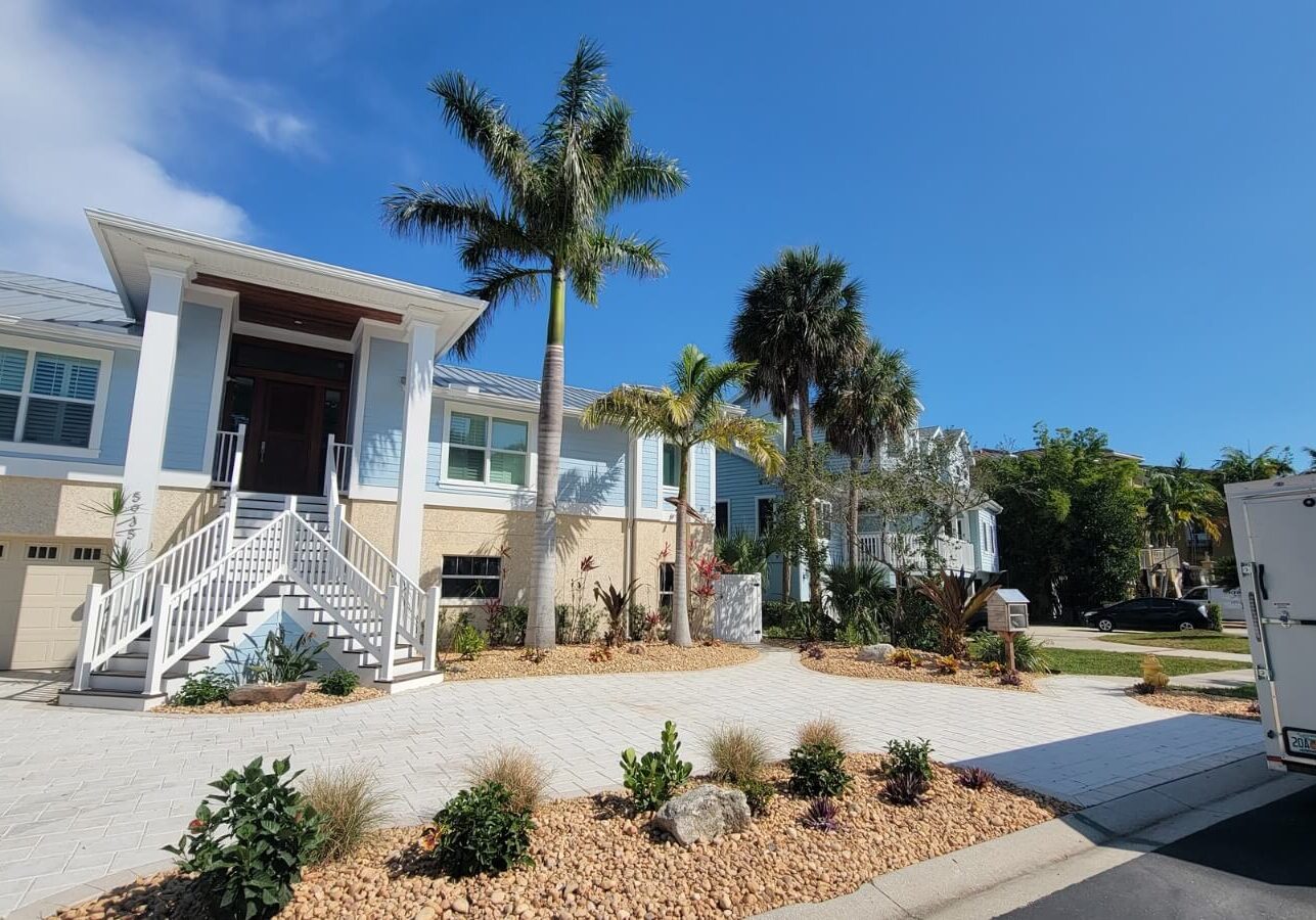 elevated home driveway palms